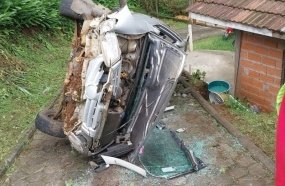 Três ficam feridos após carro capotar em rampa de residência